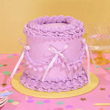 Vintage Cake - Single Colour in pastel purple with Swiss Meringue icing, decorated with ribbons by Crumbs & Doilies.